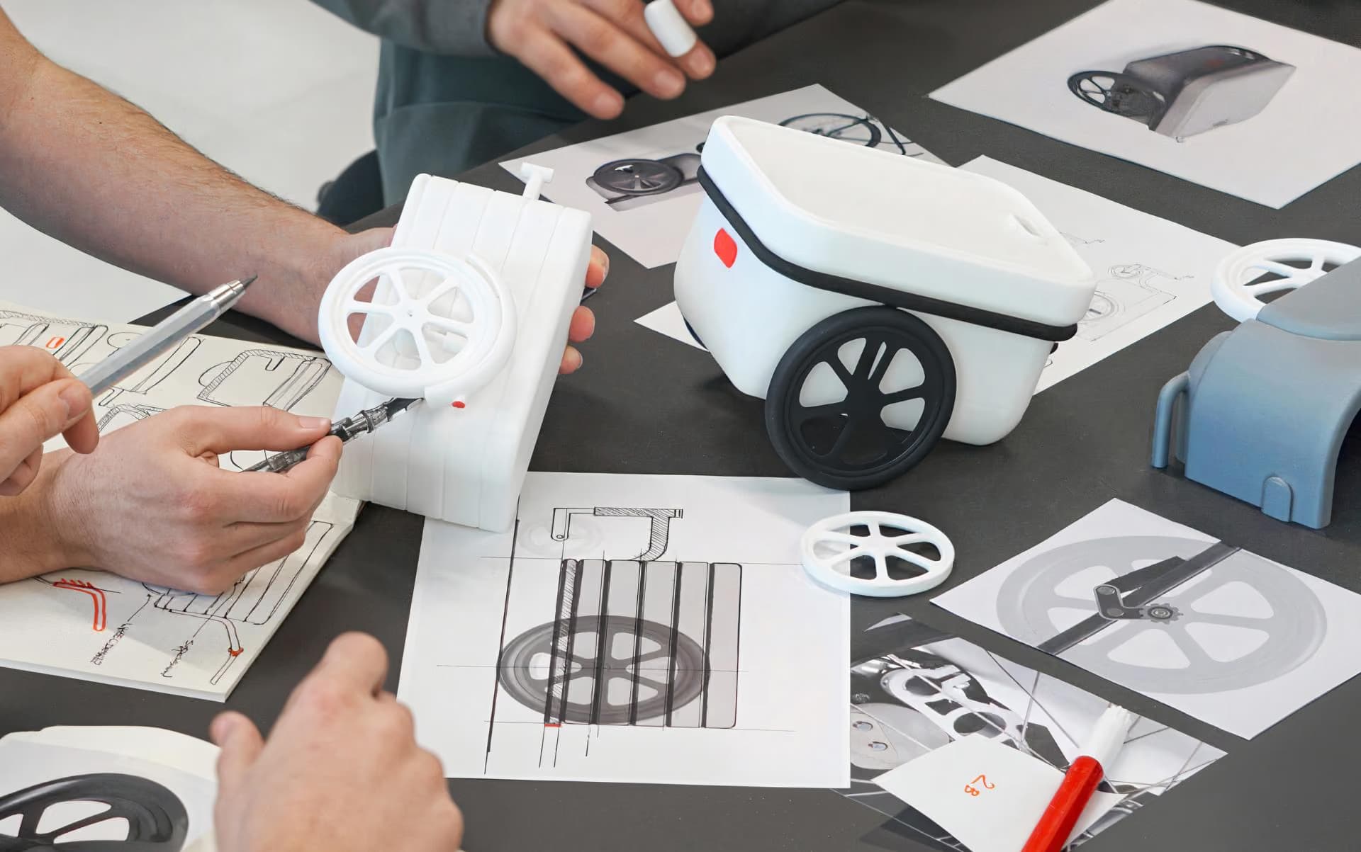 Designers sketching beside a product prototype