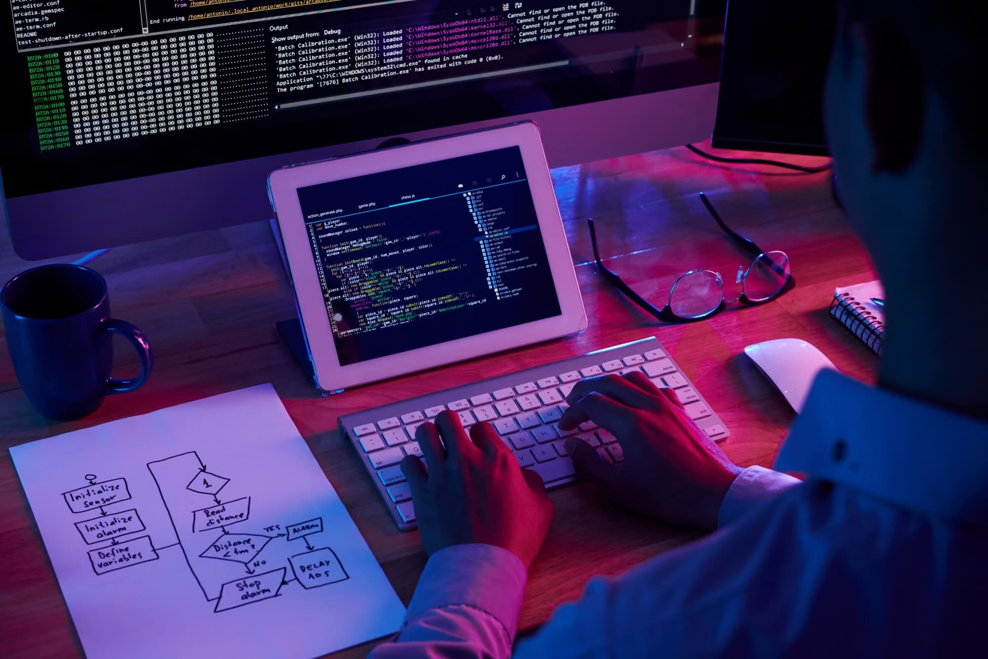 A software developer writing code at a desk